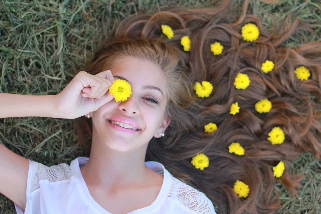 Smiling Woman Holding Yellow Flower